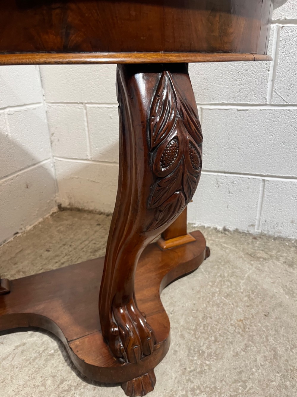 A nineteenth-century mahogany console table featuring a circular white marble top, a shaped marble splashback with an integrated shelf, and a carved central leg resting on a plinth base. View VI