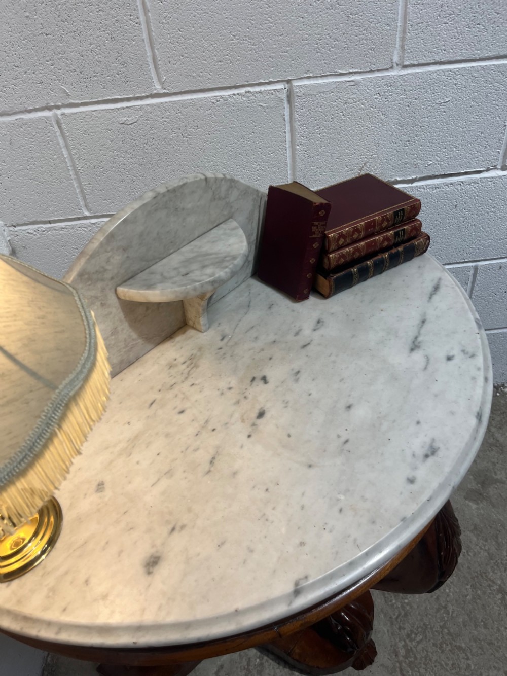 A nineteenth-century mahogany console table featuring a circular white marble top, a shaped marble splashback with an integrated shelf, and a carved central leg resting on a plinth base. View VIII