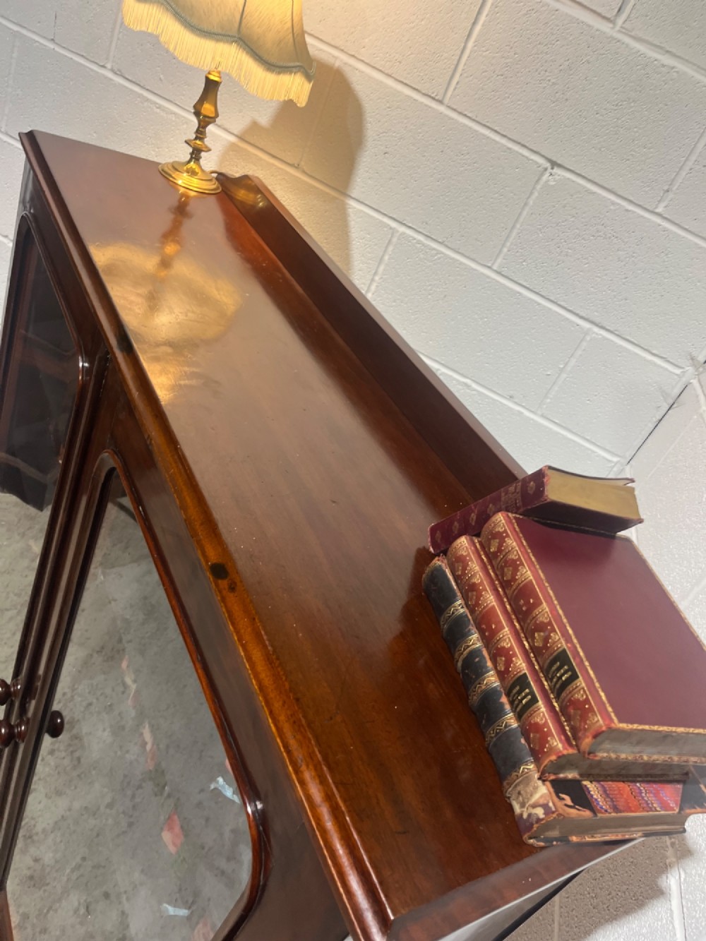 A 19th-century mahogany glazed bookcase with two glass-panelled doors revealing shelves filled with books. View VIII
