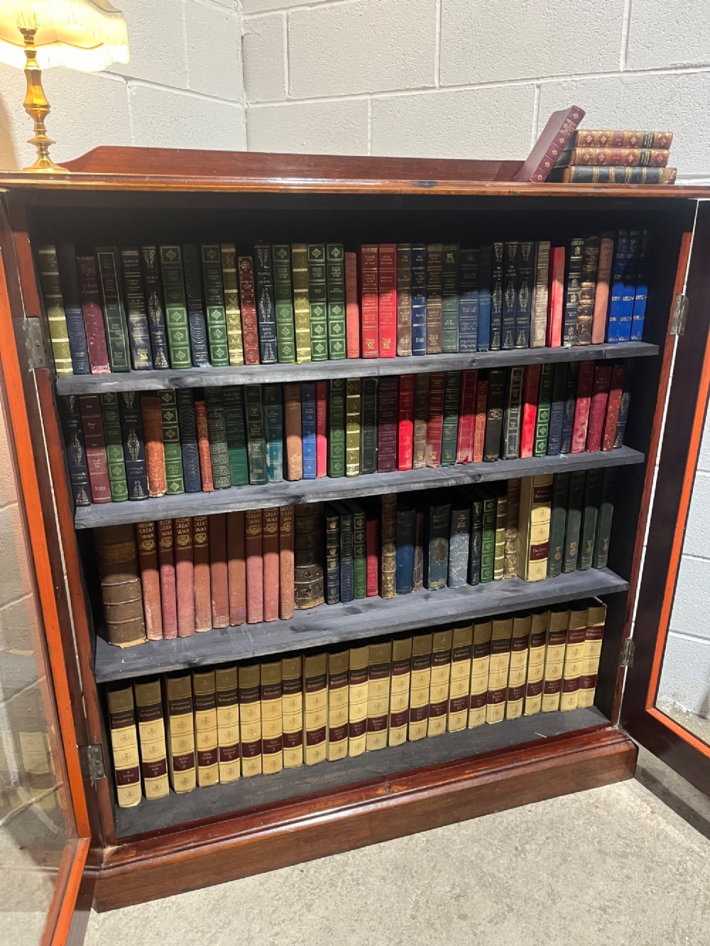 A 19th-century mahogany glazed bookcase with two glass-panelled doors revealing shelves filled with books. View X