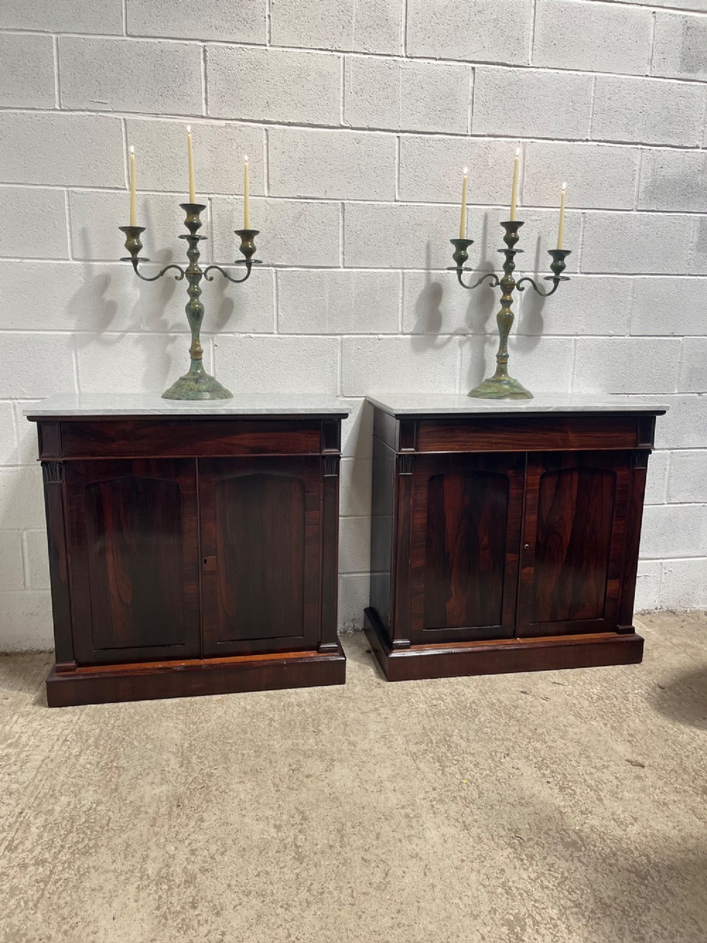A pair of 19th-century rosewood cupboards featuring dark figured wood grain, double panelled doors, and grey marble tops. View II