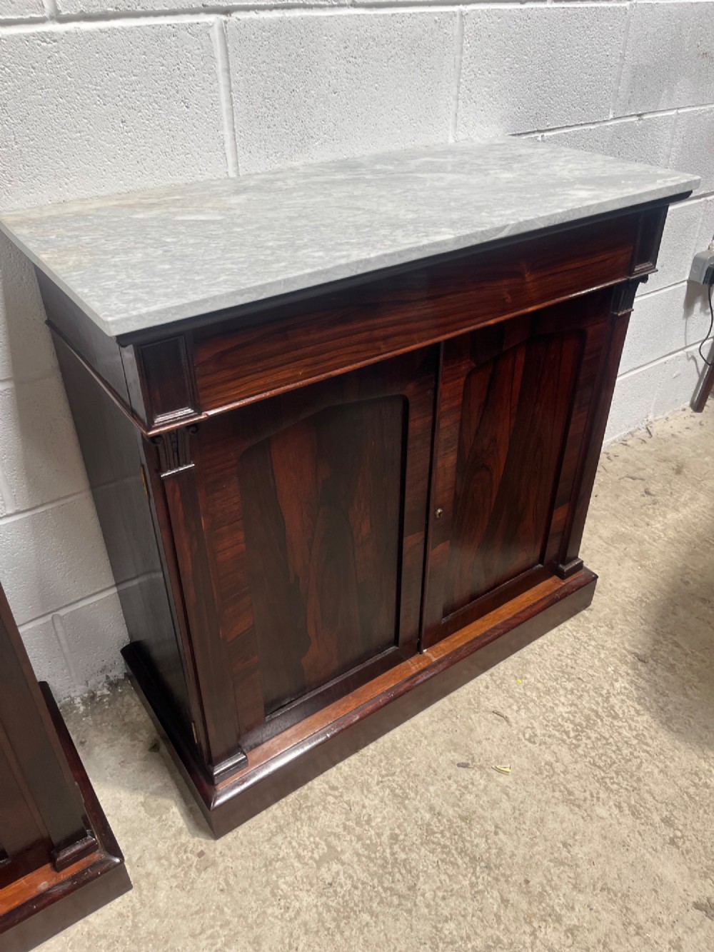 A pair of 19th-century rosewood cupboards featuring dark figured wood grain, double panelled doors, and grey marble tops. View VII