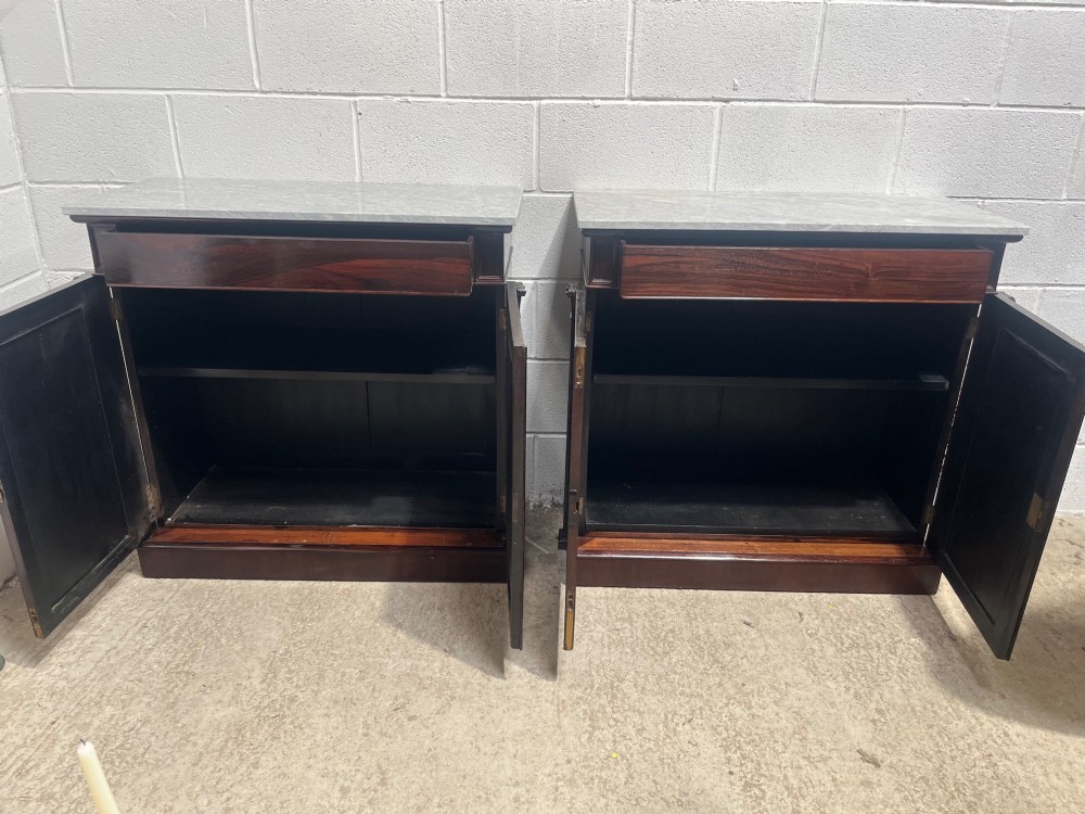 A pair of 19th-century rosewood cupboards featuring dark figured wood grain, double panelled doors, and grey marble tops. View X