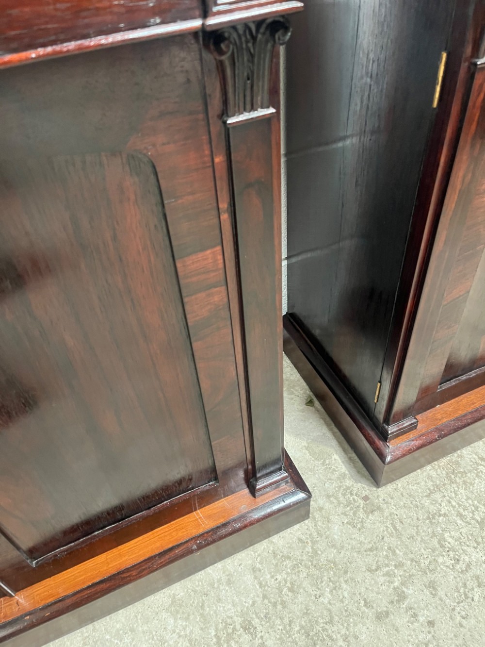 A pair of 19th-century rosewood cupboards featuring dark figured wood grain, double panelled doors, and grey marble tops. View XI