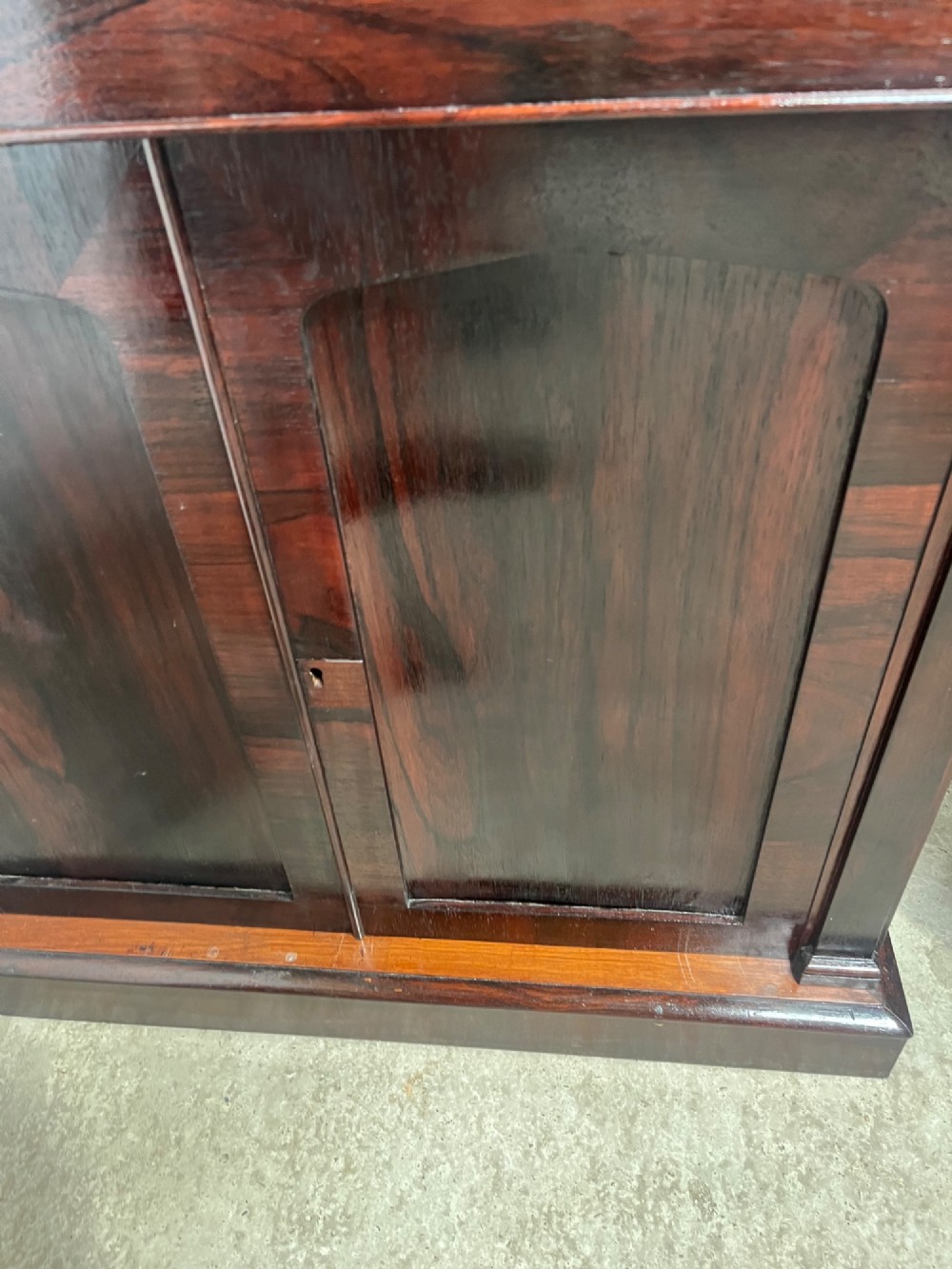 A pair of 19th-century rosewood cupboards featuring dark figured wood grain, double panelled doors, and grey marble tops. View XII