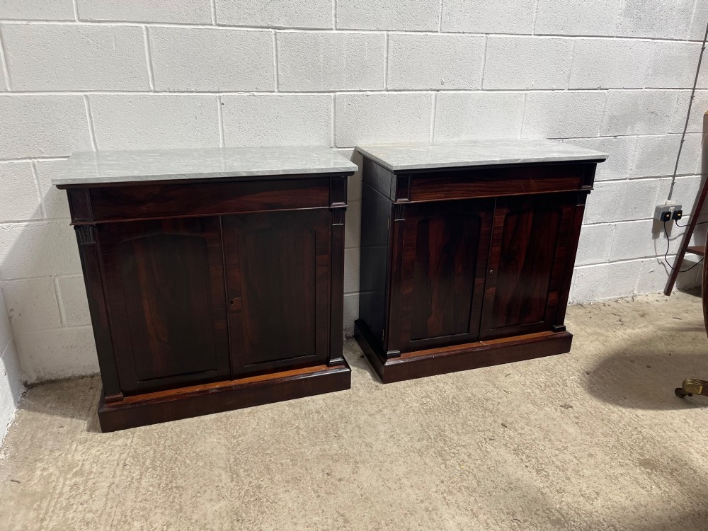 A pair of 19th-century rosewood cupboards featuring dark figured wood grain, double panelled doors, and grey marble tops. View XV