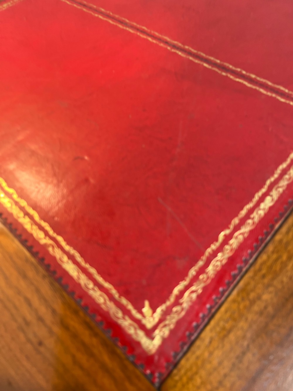 A 19th-century mahogany free-standing pedestal desk featuring a red leather top inset, multiple drawers with turned knobs, and brass castors. View XI