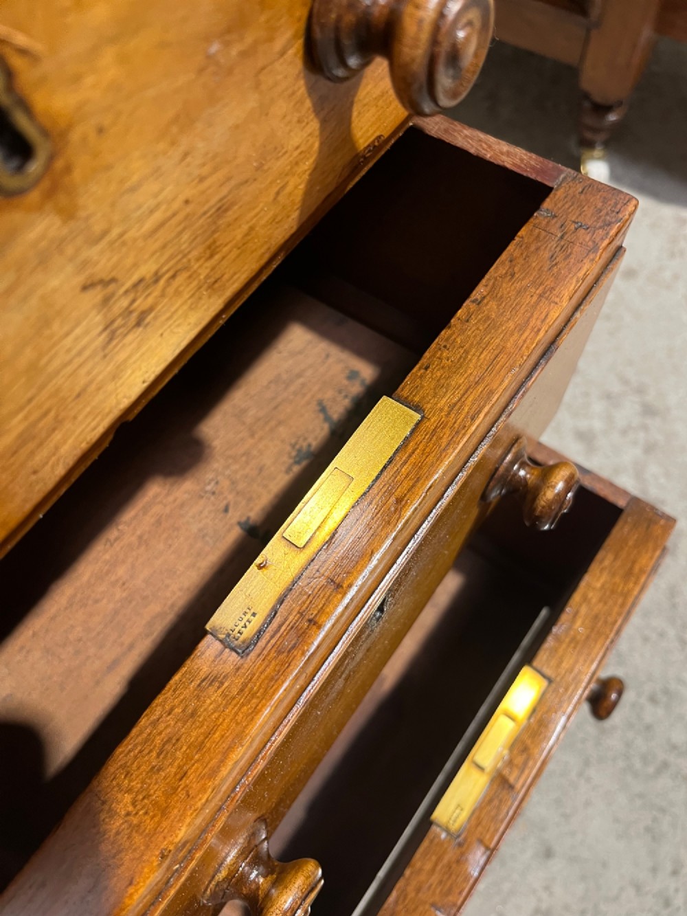 A 19th-century mahogany free-standing pedestal desk featuring a red leather top inset, multiple drawers with turned knobs, and brass castors. View XIV