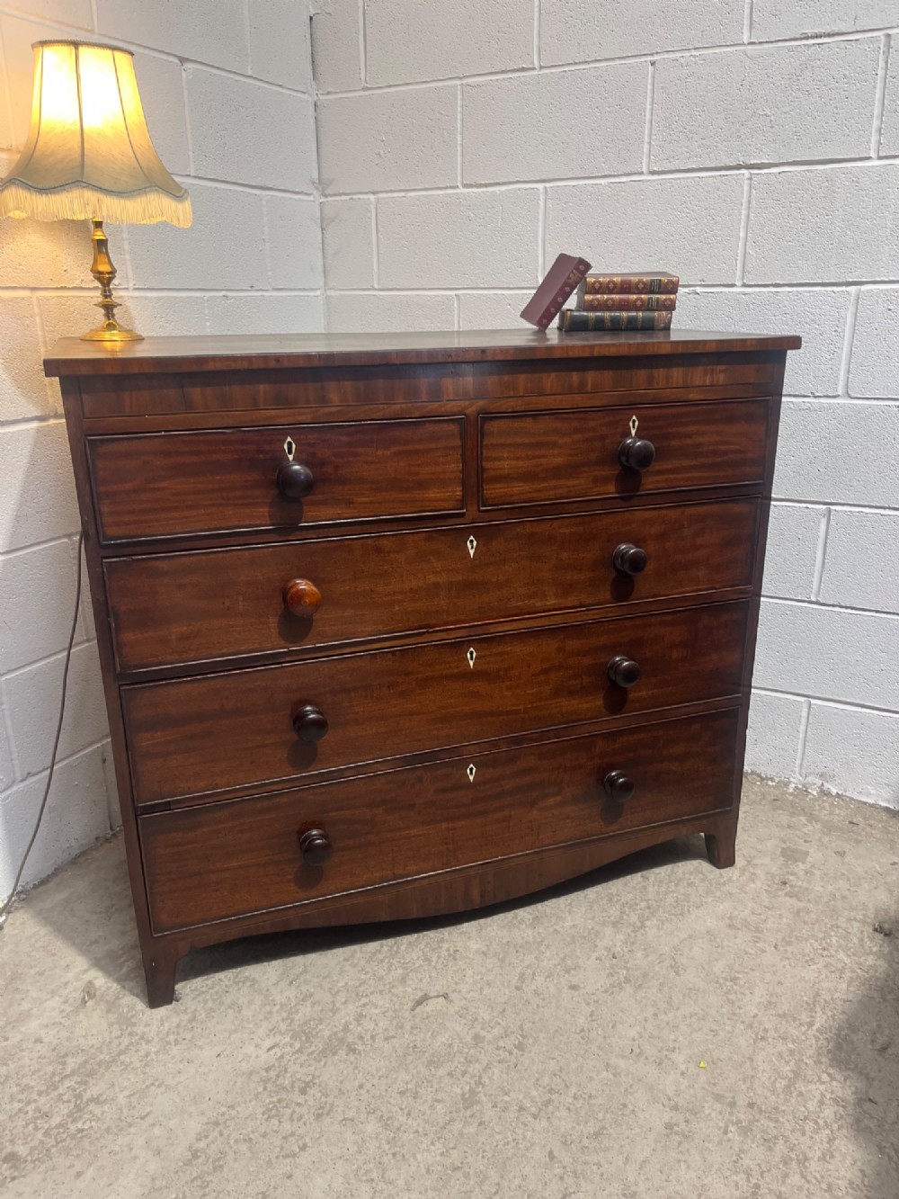 A 19th-century mahogany chest of drawers featuring two short drawers over three long drawers with turned handles and diamond escutcheons. View II