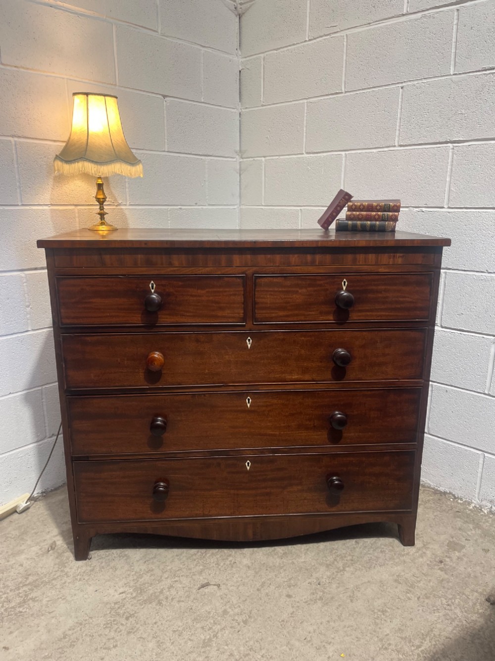 A 19th-century mahogany chest of drawers featuring two short drawers over three long drawers with turned handles and diamond escutcheons. View III
