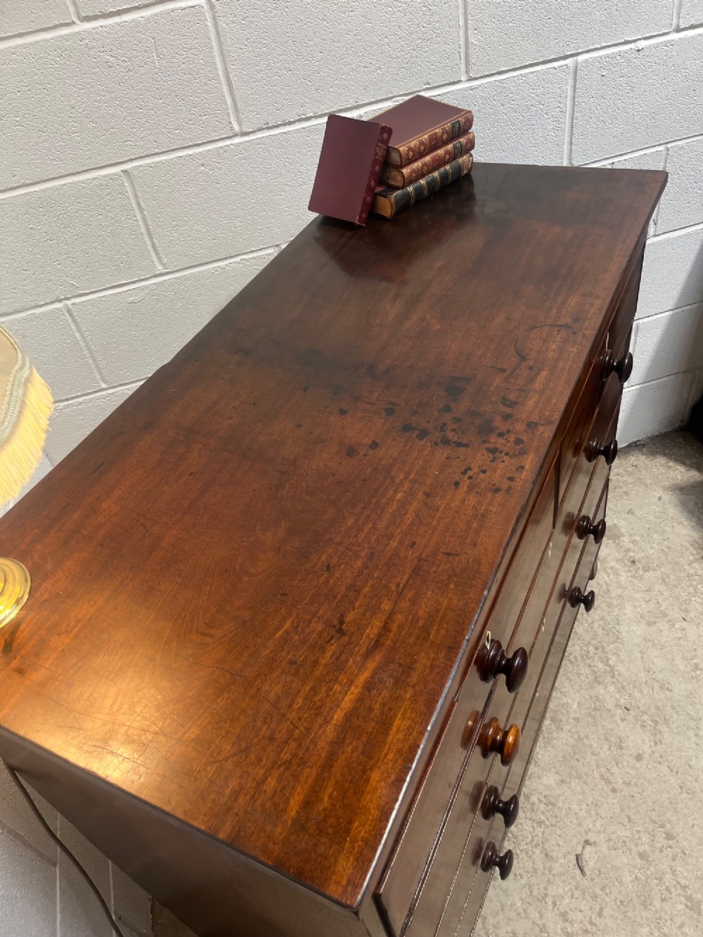 A 19th-century mahogany chest of drawers featuring two short drawers over three long drawers with turned handles and diamond escutcheons. View VI