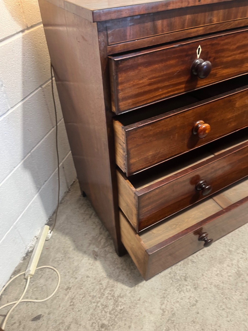 A 19th-century mahogany chest of drawers featuring two short drawers over three long drawers with turned handles and diamond escutcheons. View IX
