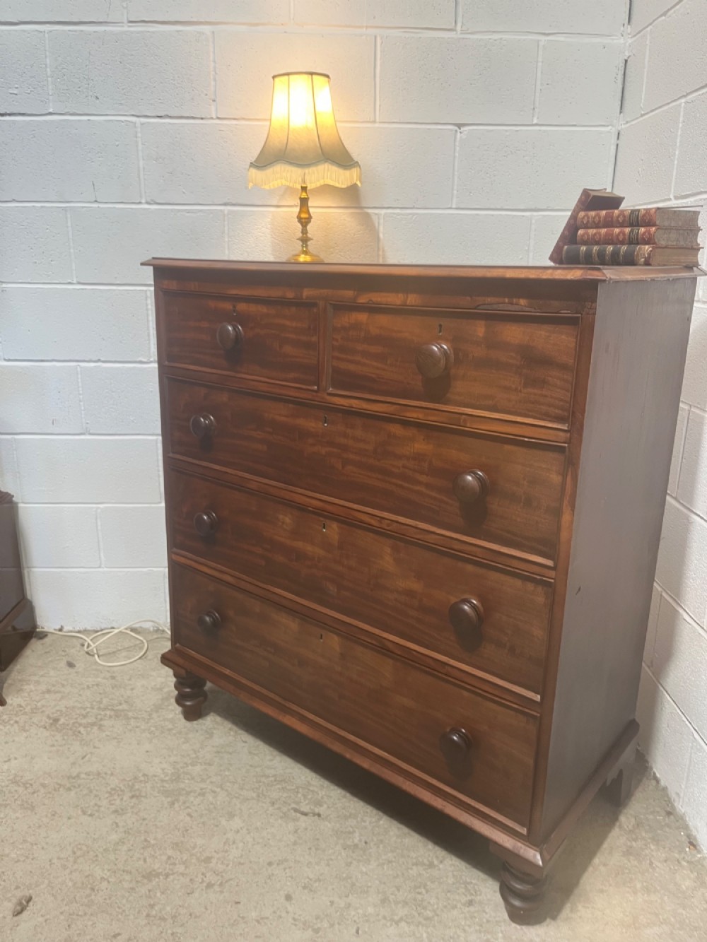 A 19th-century mahogany chest of drawers with a two-over-three drawer configuration, turned wooden knobs, and turned bun feet. View II
