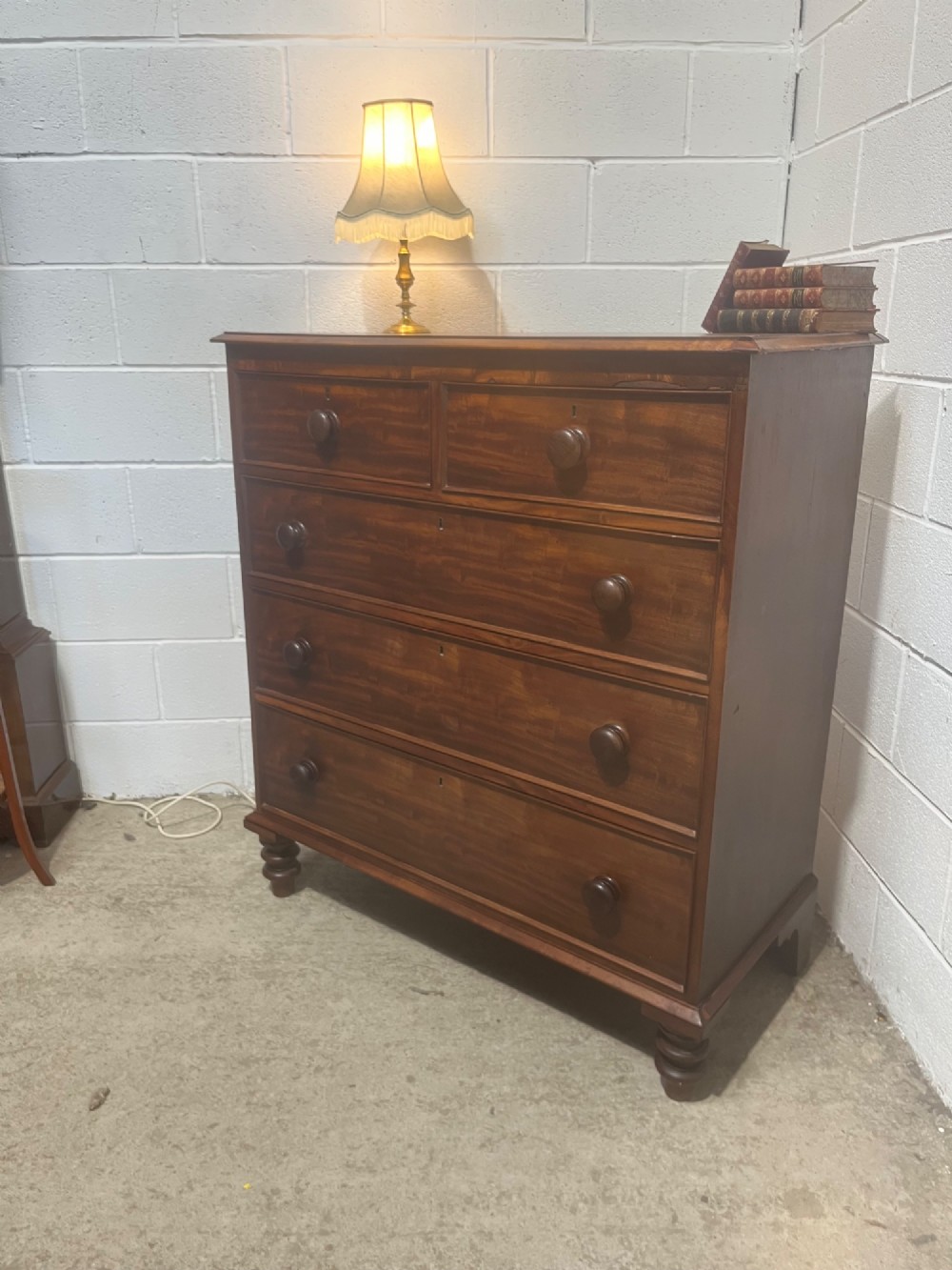 A 19th-century mahogany chest of drawers with a two-over-three drawer configuration, turned wooden knobs, and turned bun feet. View III