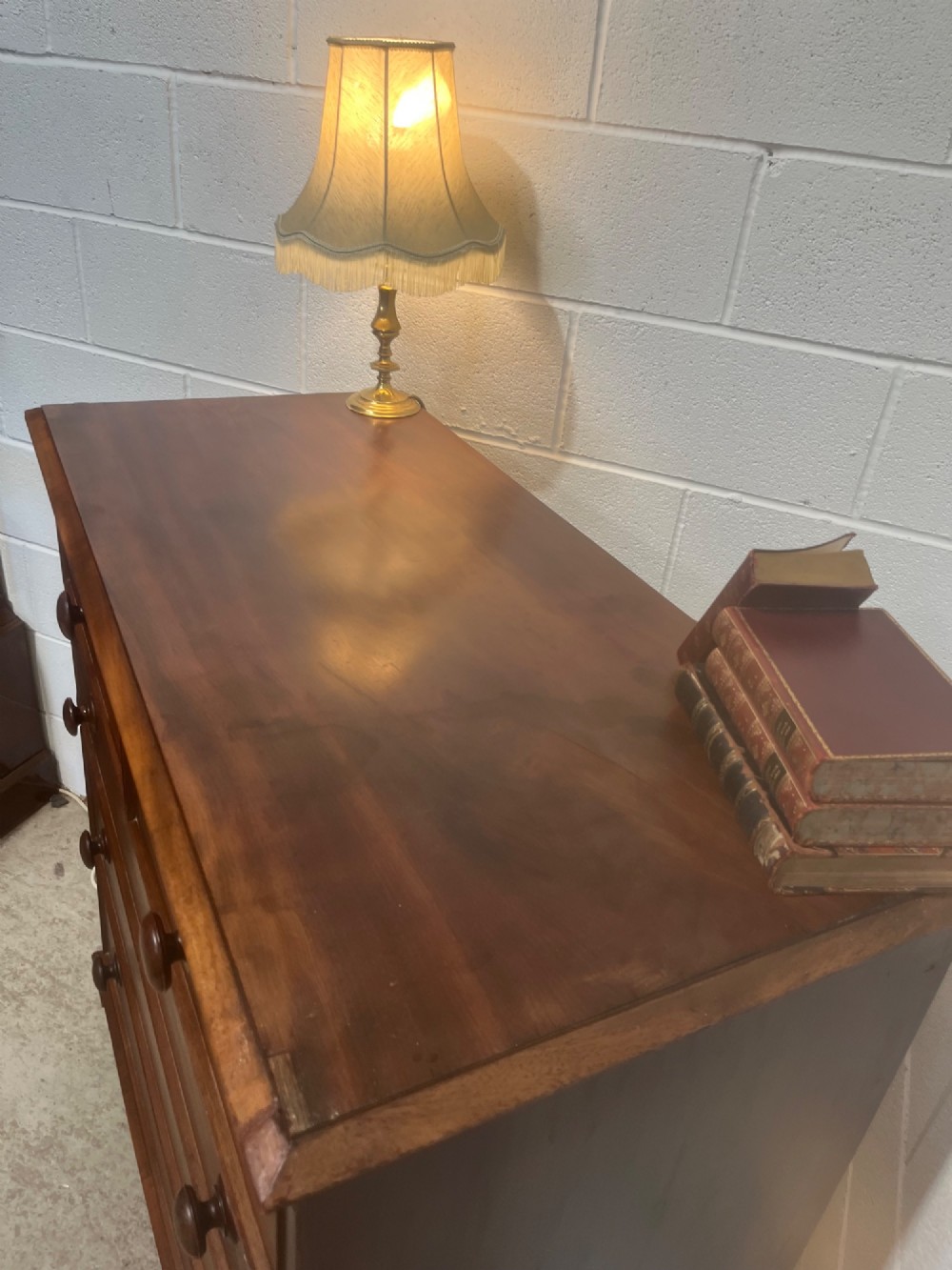 A 19th-century mahogany chest of drawers with a two-over-three drawer configuration, turned wooden knobs, and turned bun feet. View IV