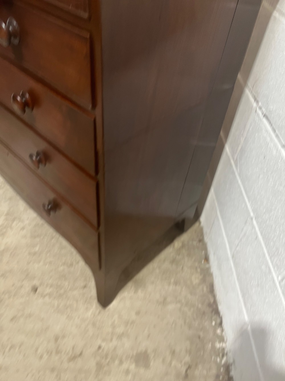 A nineteenth-century mahogany chest of drawers featuring five heights of drawers, turned wooden handles, and splayed feet. View VII
