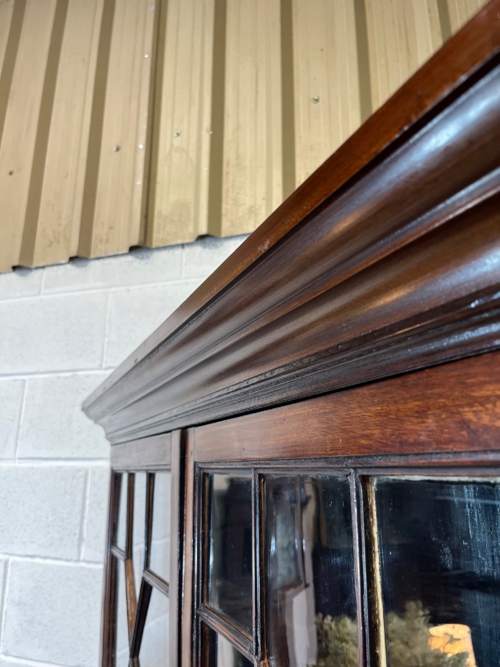 A tall 19th-century mahogany bookcase featuring upper astragal glazed doors above a lower two-door solid panelled cupboard. View VII