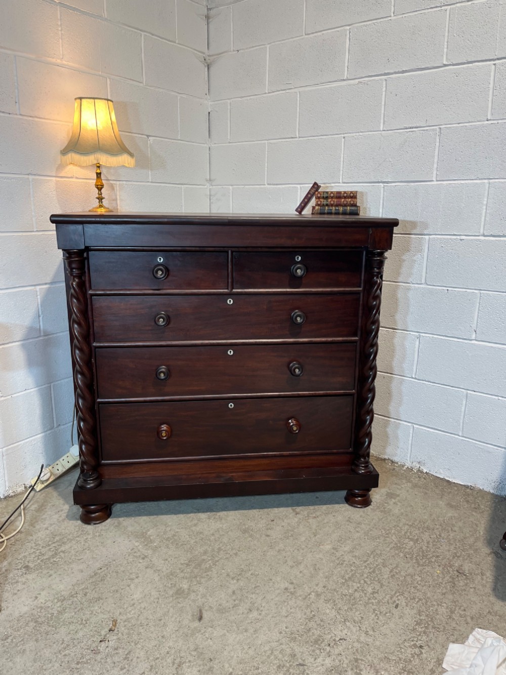 A 19th-century dark mahogany Scotch chest of drawers featuring spiral barley twist side columns, turned wooden knobs, and a heavy plinth base. View II