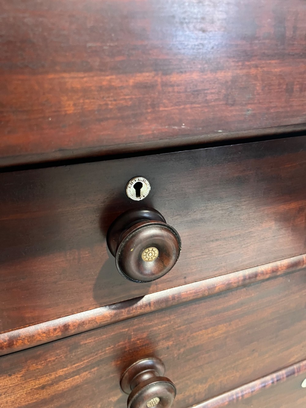 A 19th-century dark mahogany Scotch chest of drawers featuring spiral barley twist side columns, turned wooden knobs, and a heavy plinth base. View VIII