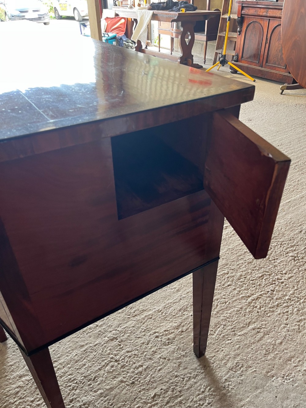 A Georgian mahogany sideboard featuring flame mahogany drawer fronts, brass ring handles, decorative line inlay, and fluted tapered legs. View IX