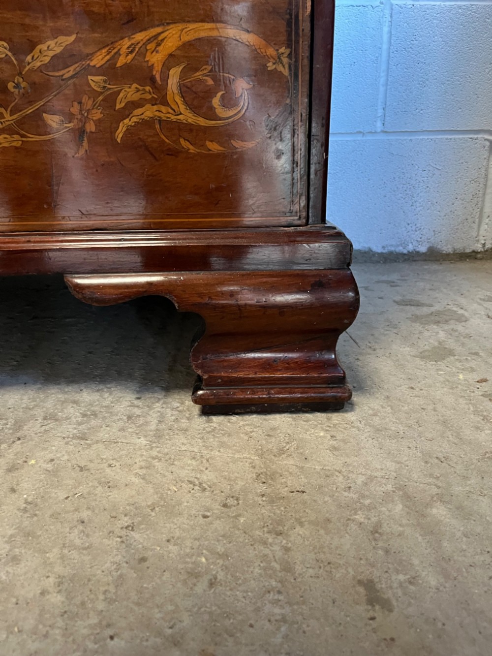 A 19th-century mahogany secretaire bookcase featuring an upper cabinet with geometric astragal glazed doors above a chest of drawers embellished with floral marquetry inlay. View VII