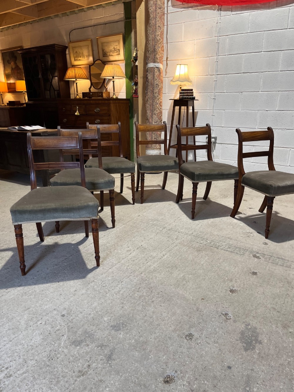 Set of six Regency mahogany dining chairs featuring horizontal bar backrests, green velvet seats, turned front legs, and splayed rear legs. View II
