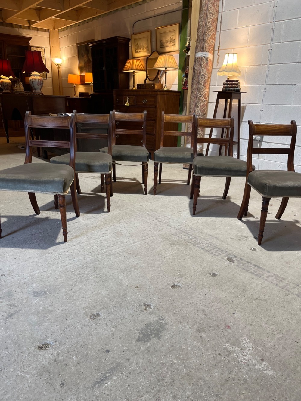 Set of six Regency mahogany dining chairs featuring horizontal bar backrests, green velvet seats, turned front legs, and splayed rear legs. View III