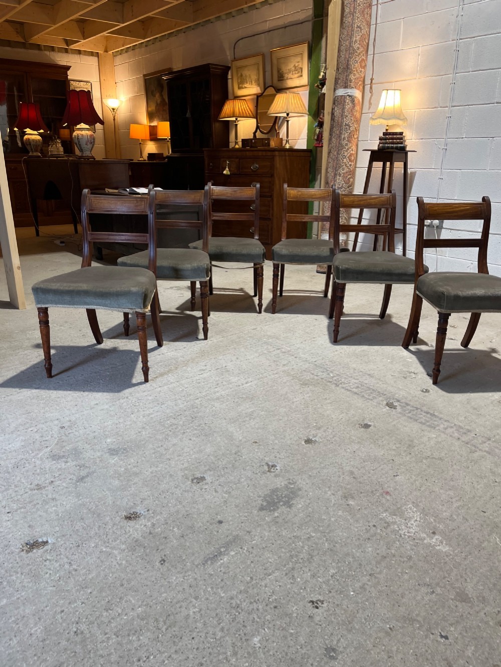 Set of six Regency mahogany dining chairs featuring horizontal bar backrests, green velvet seats, turned front legs, and splayed rear legs. View IV
