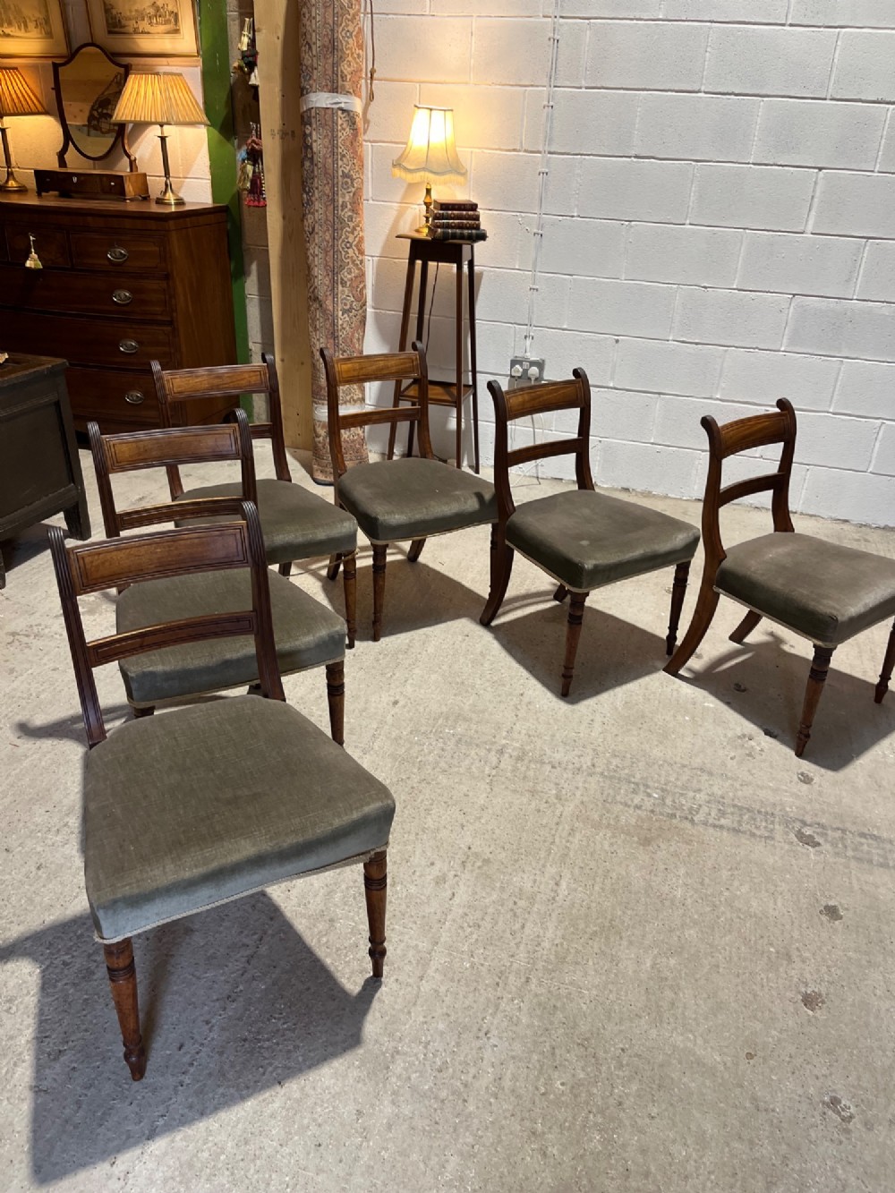 Set of six Regency mahogany dining chairs featuring horizontal bar backrests, green velvet seats, turned front legs, and splayed rear legs. View IX