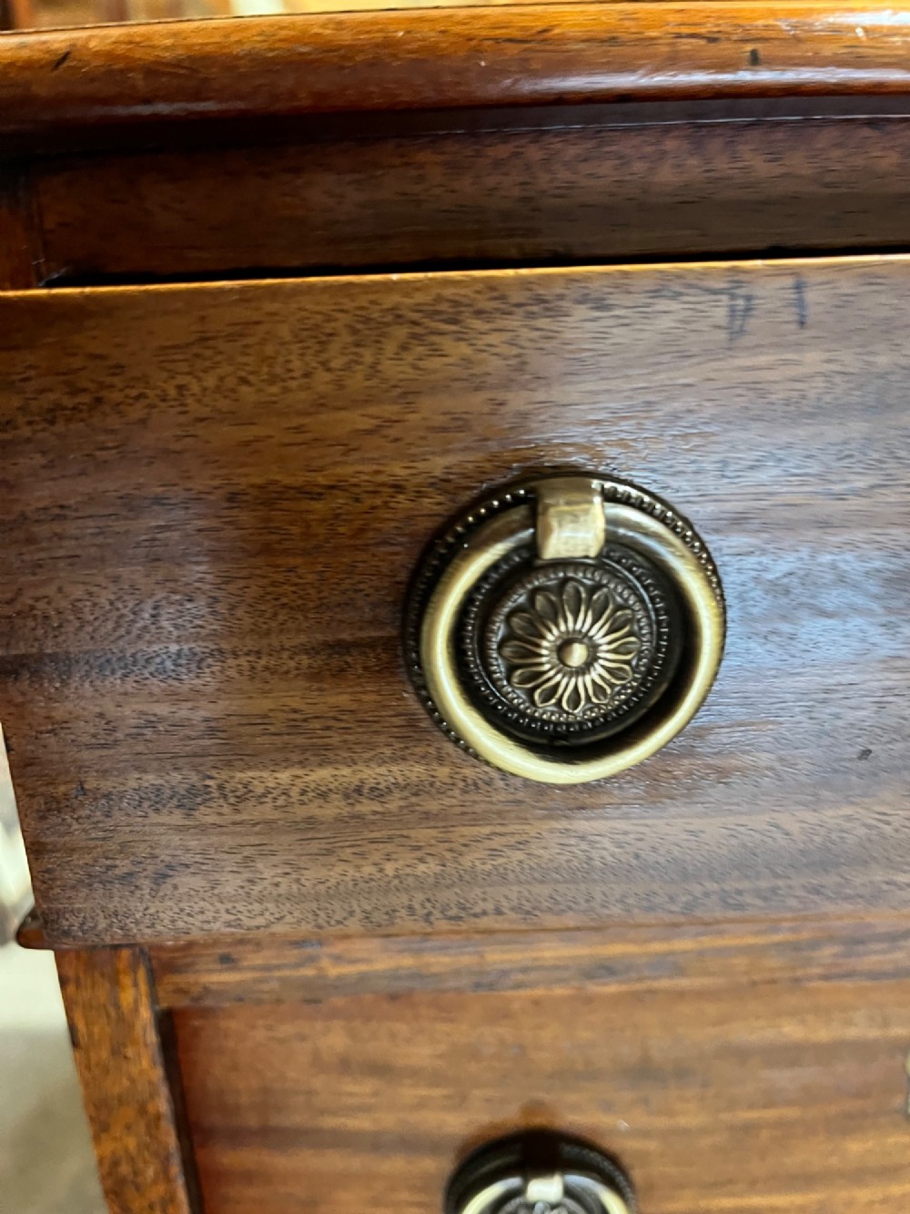 A 19th-century mahogany pedestal desk featuring an inset green leather top, brass ring pull handles, and nine drawers over plinth bases. View VII