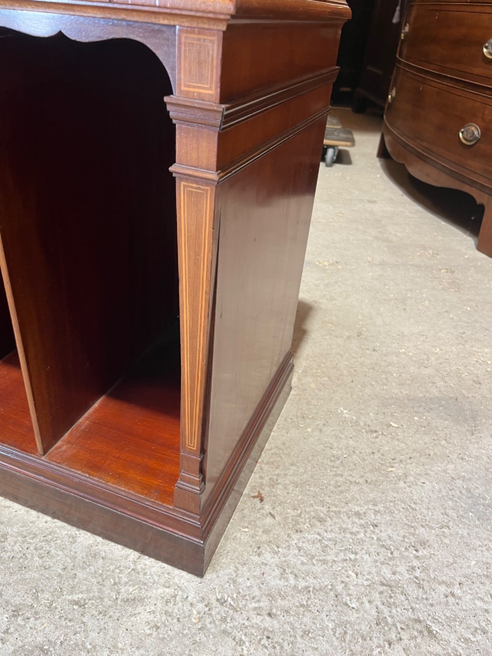 A late 19th-century inlaid mahogany cabinet featuring a grey marble surface, four drawers with string inlay and brass drop handles, above four vertical open storage divisions. View VII