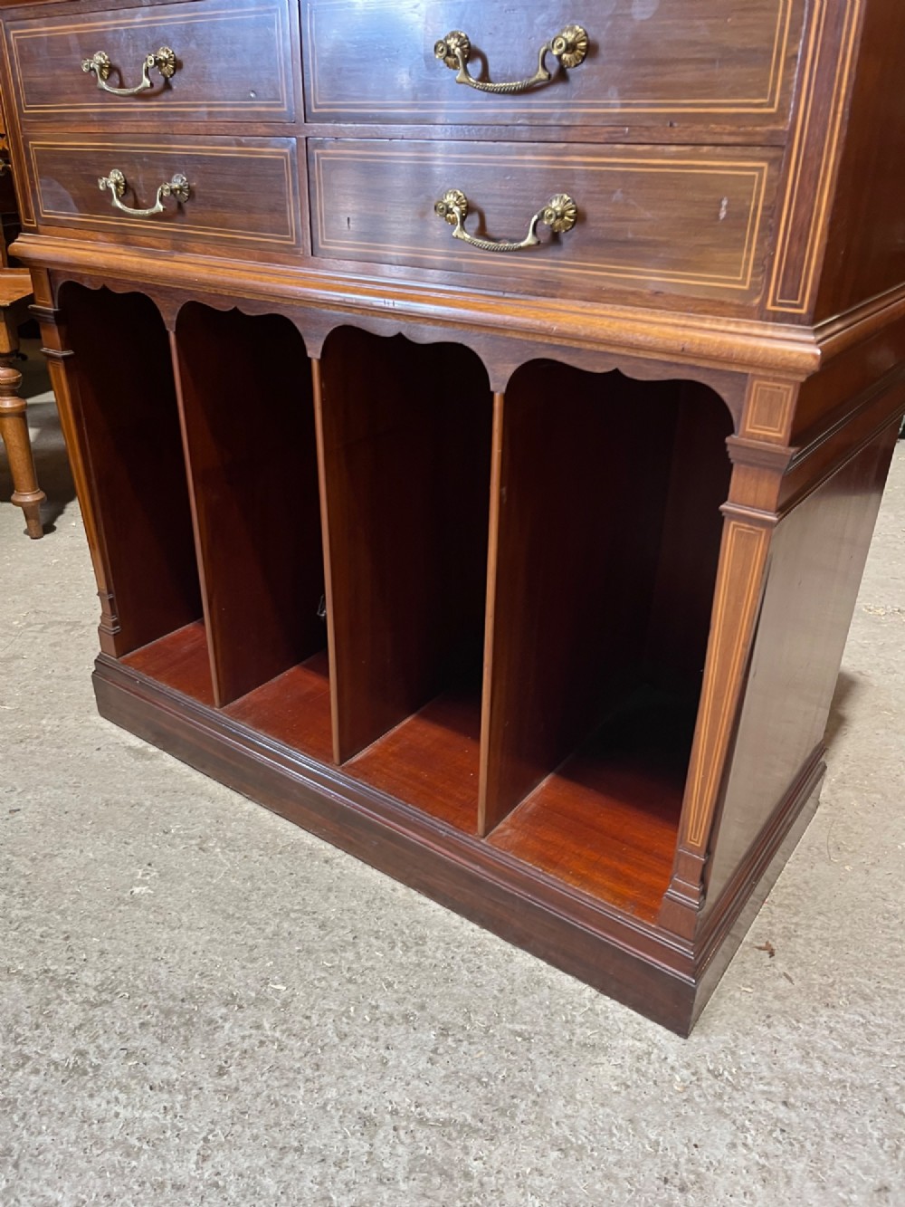 A late 19th-century inlaid mahogany cabinet featuring a grey marble surface, four drawers with string inlay and brass drop handles, above four vertical open storage divisions. View IX