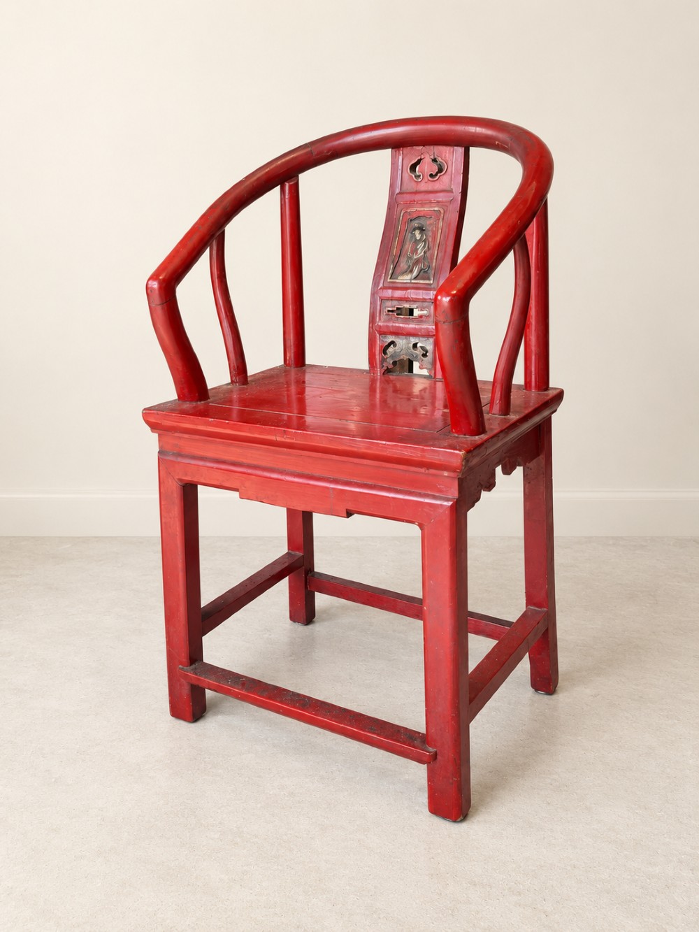 A traditional red lacquered Chinese armchair featuring a curved horseshoe backrest and a carved central splat. View III