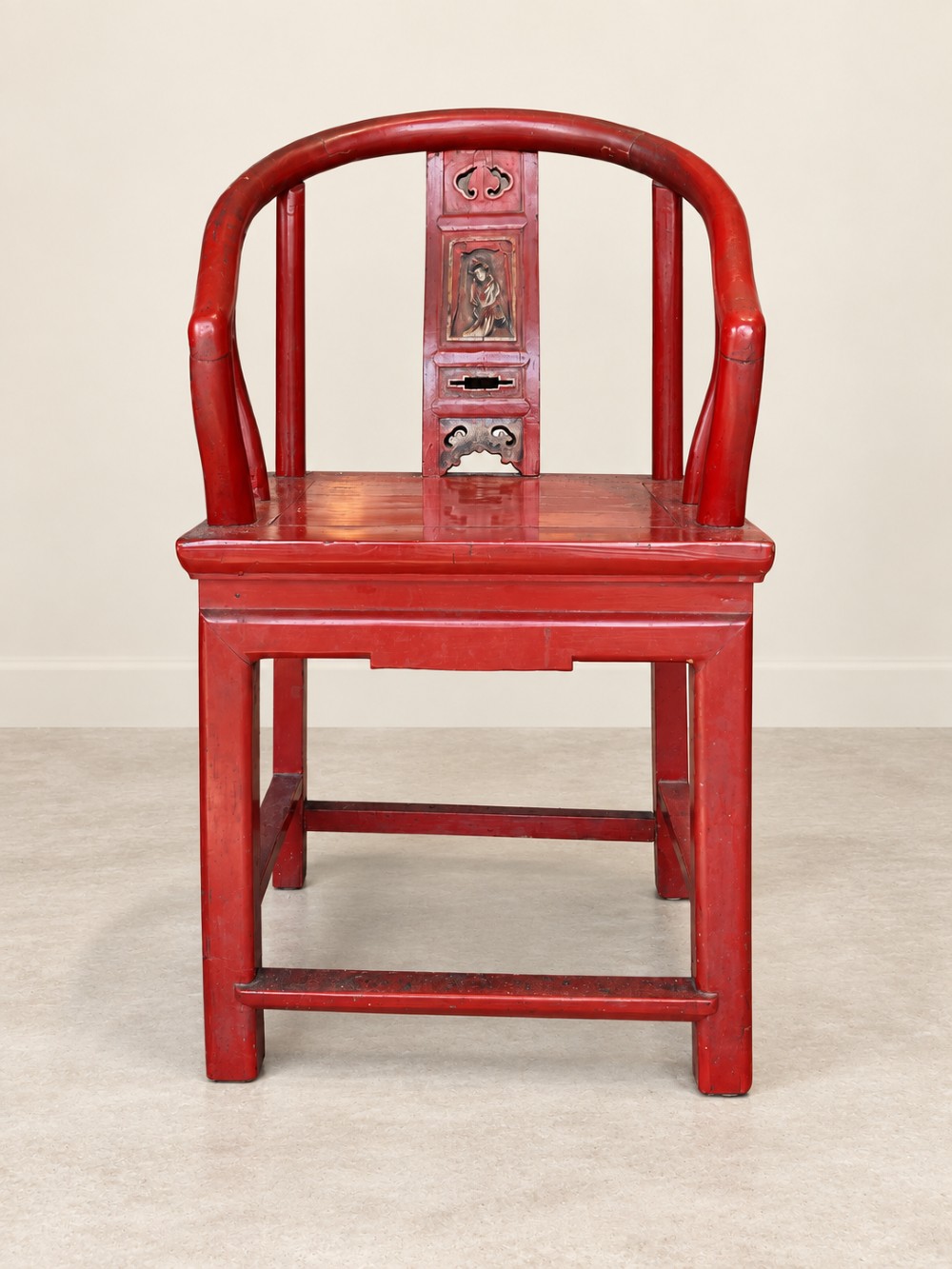A traditional red lacquered Chinese armchair featuring a curved horseshoe backrest and a carved central splat. View IV