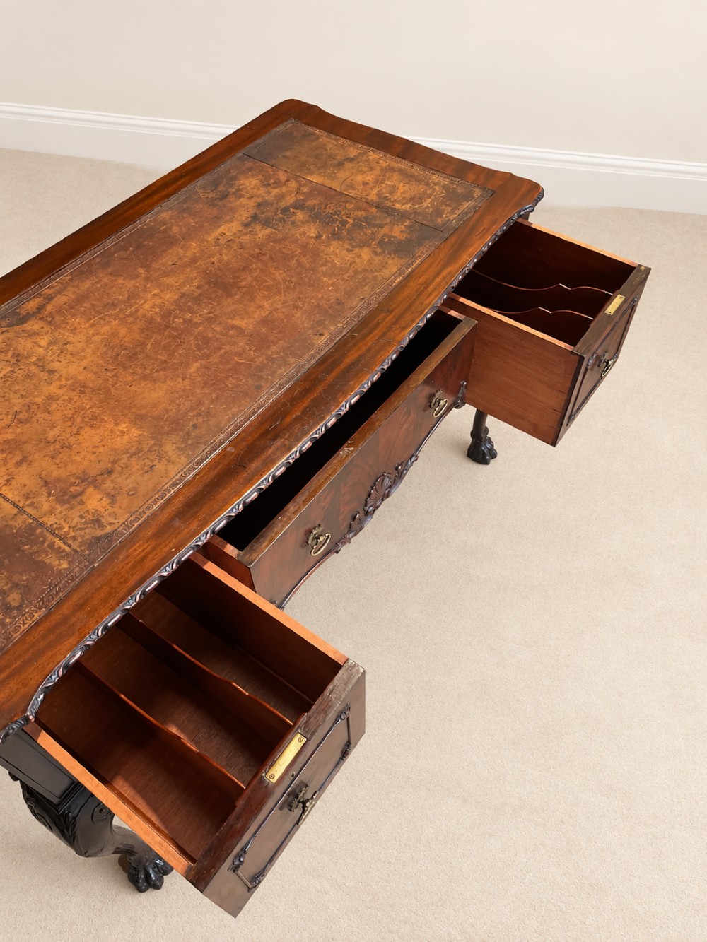 A dark mahogany writing table featuring three drawers, a carved shell apron, and cabriole legs with ball-and-claw feet. View VII