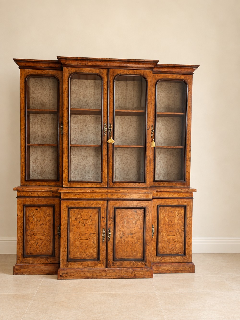 A nineteenth-century inlaid walnut breakfront bookcase featuring four upper glazed doors and four lower wooden cupboard doors decorated with floral marquetry. View II