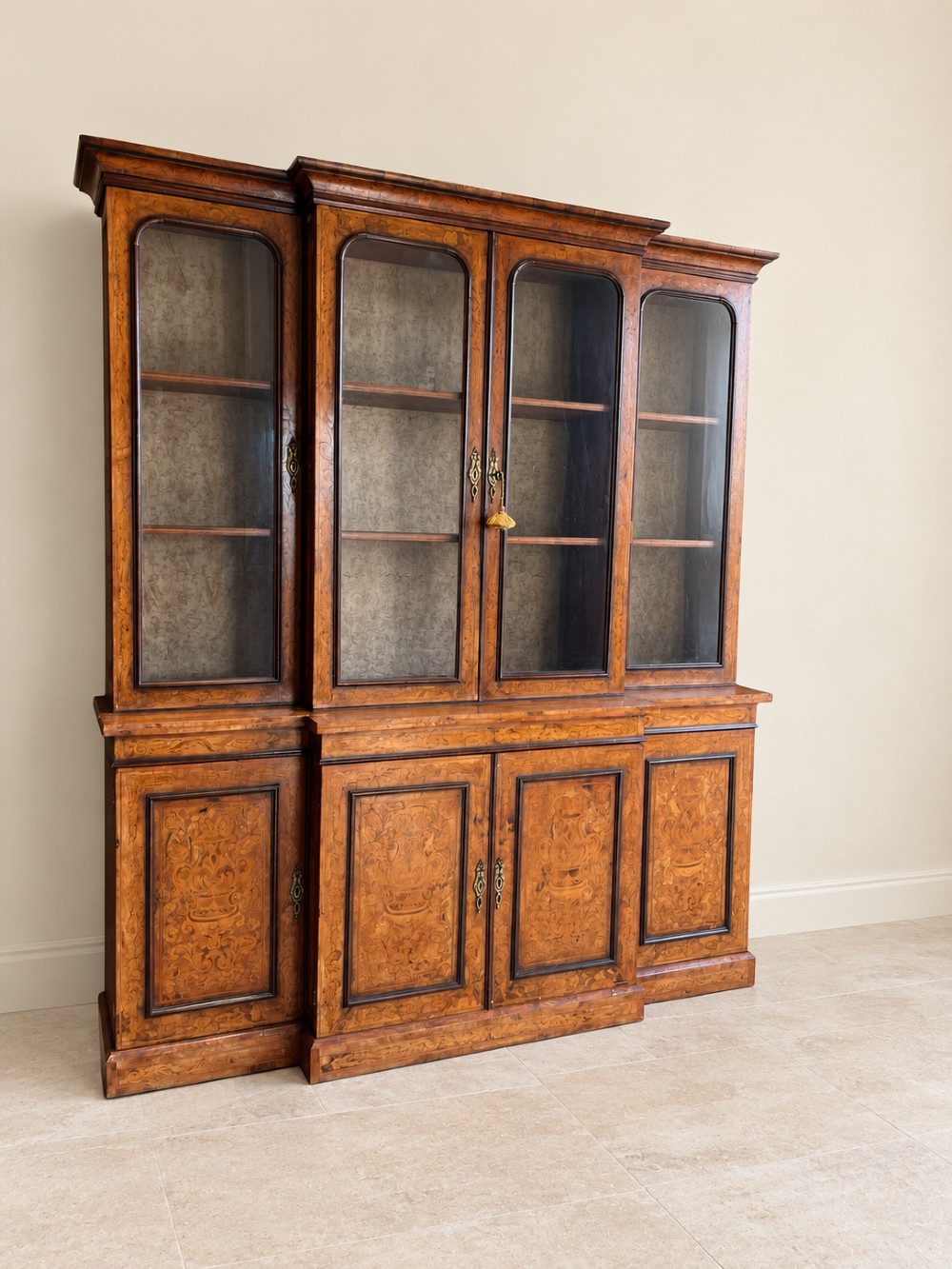 A nineteenth-century inlaid walnut breakfront bookcase featuring four upper glazed doors and four lower wooden cupboard doors decorated with floral marquetry. View III