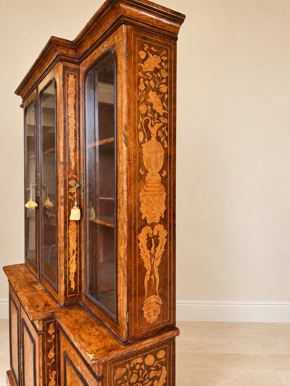 A nineteenth-century inlaid walnut breakfront bookcase featuring four upper glazed doors and four lower wooden cupboard doors decorated with floral marquetry. View V