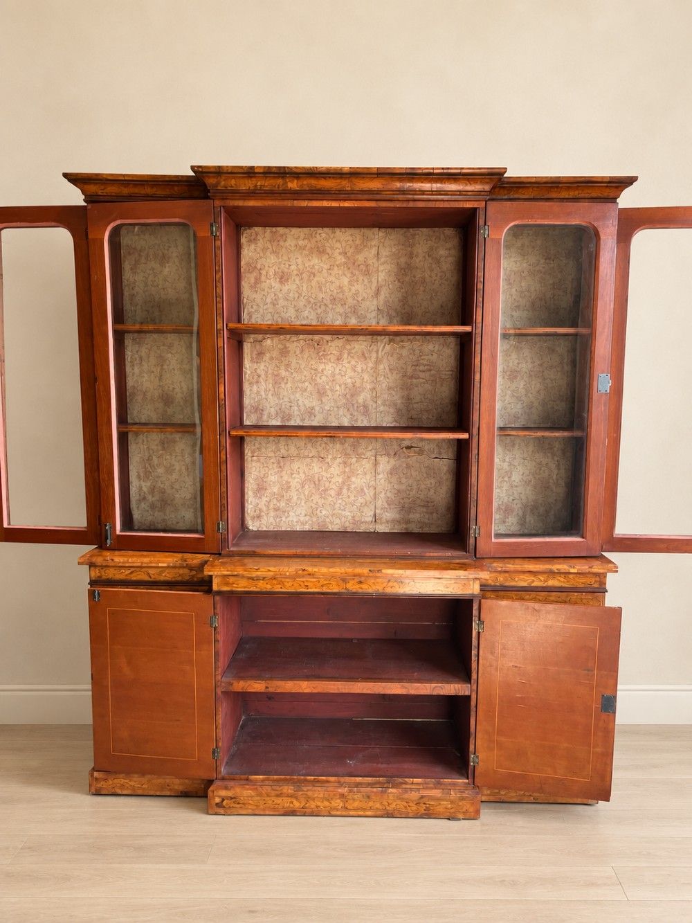 A nineteenth-century inlaid walnut breakfront bookcase featuring four upper glazed doors and four lower wooden cupboard doors decorated with floral marquetry. View VI