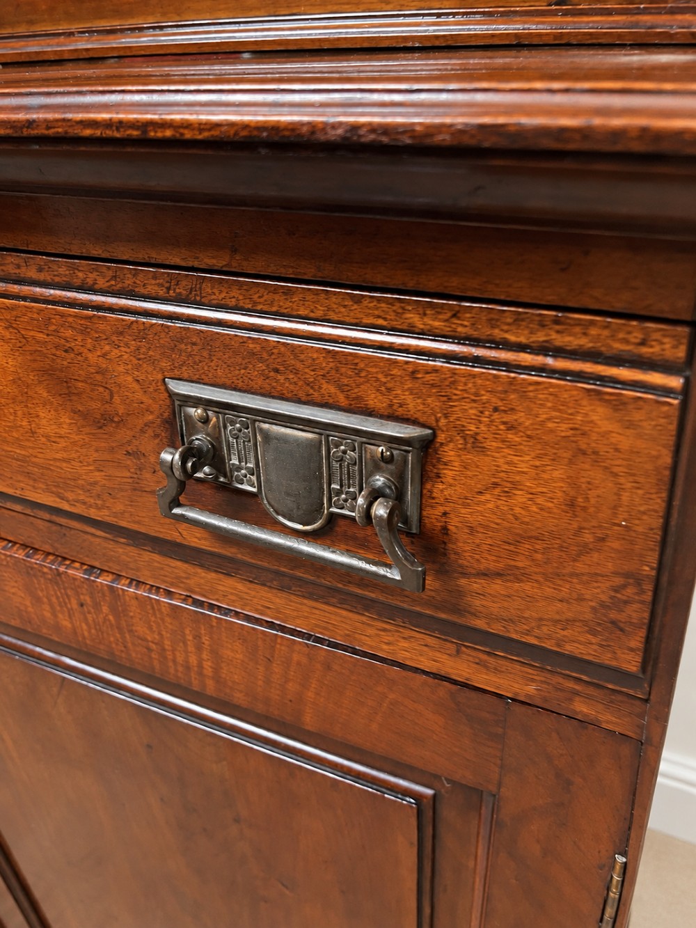 A late nineteenth-century mahogany bookcase featuring two glass-front upper doors above two drawers and a double cupboard base. View IX