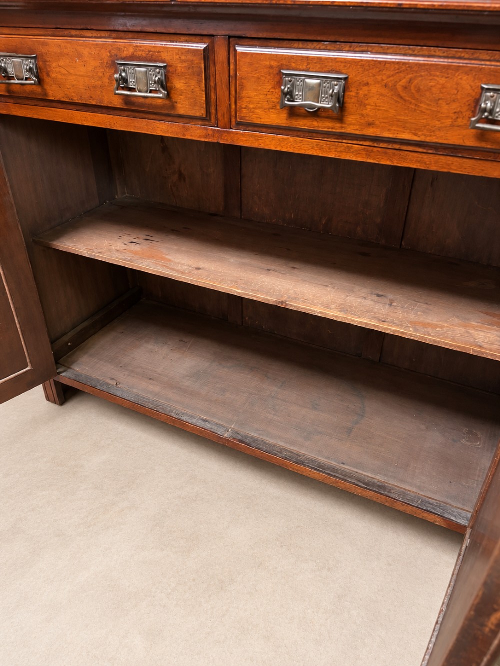 A late nineteenth-century mahogany bookcase featuring two glass-front upper doors above two drawers and a double cupboard base. View X
