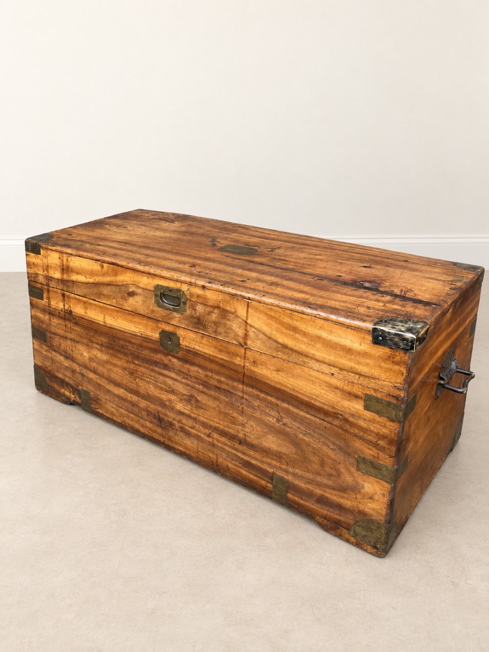 A 19th-century rectangular wooden campaign chest featuring protective brass corner brackets, flush carrying handles, and a hinged lid. View III