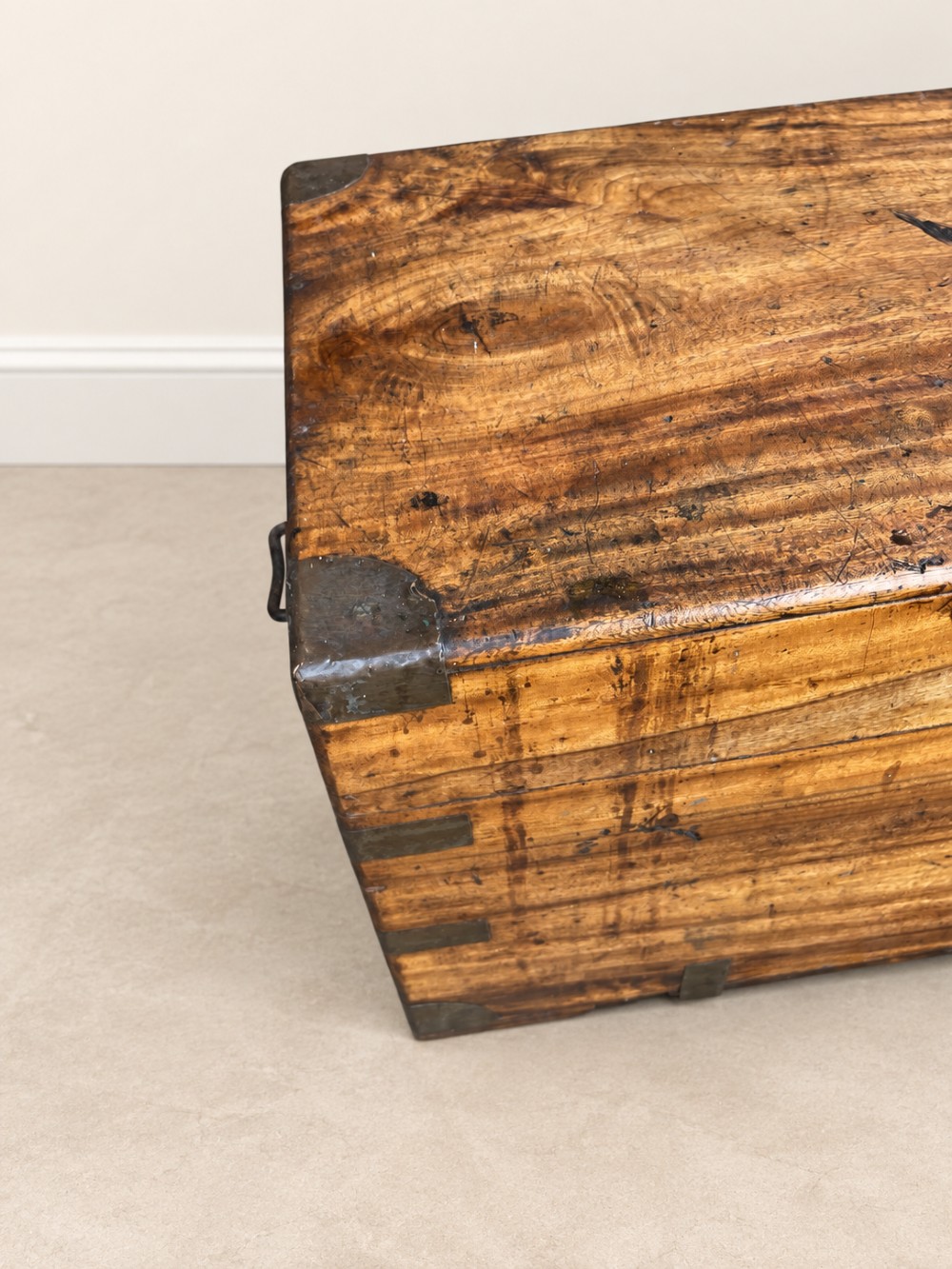 A 19th-century rectangular wooden campaign chest featuring protective brass corner brackets, flush carrying handles, and a hinged lid. View IV