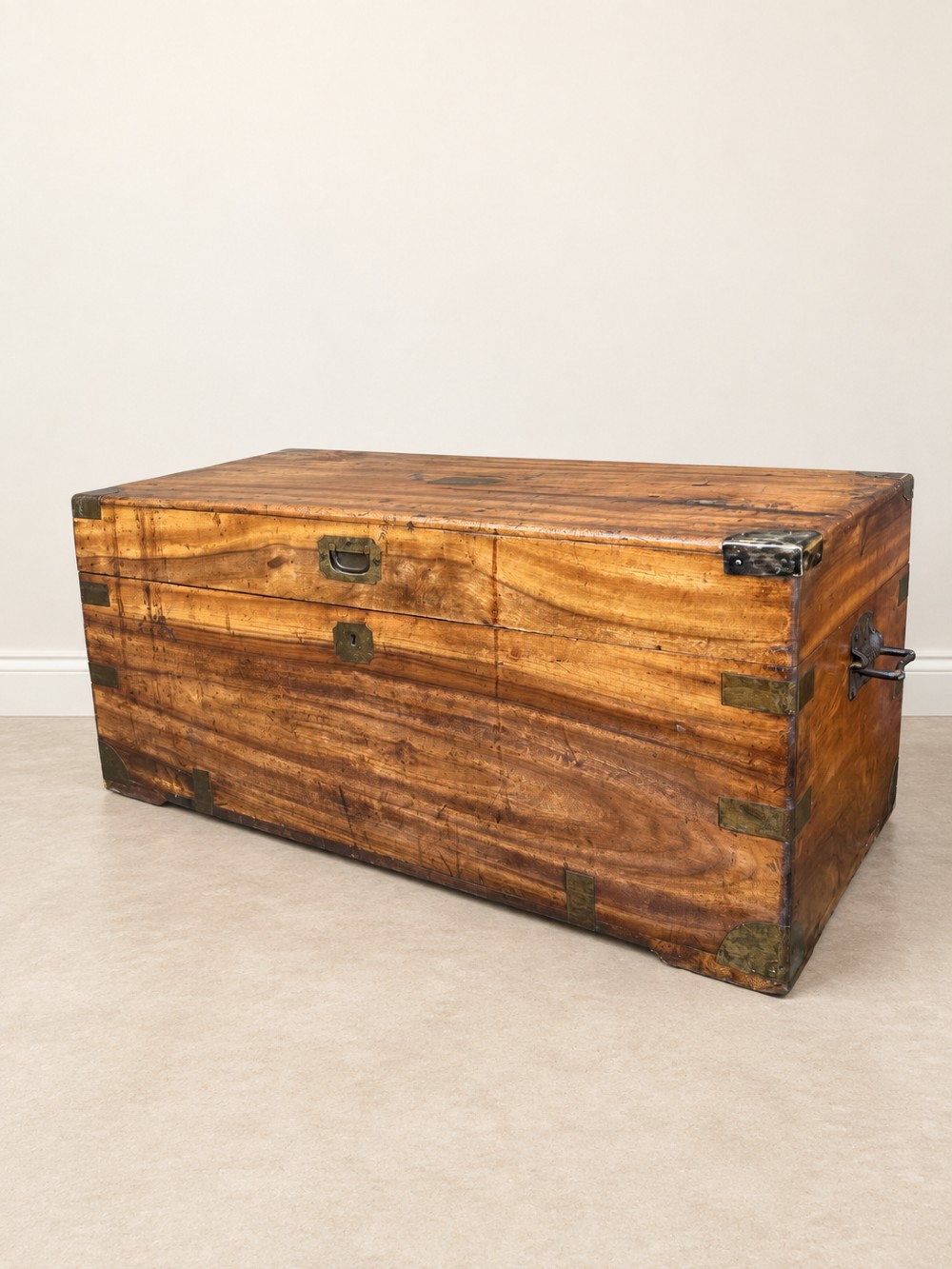 A 19th-century rectangular wooden campaign chest featuring protective brass corner brackets, flush carrying handles, and a hinged lid. View V