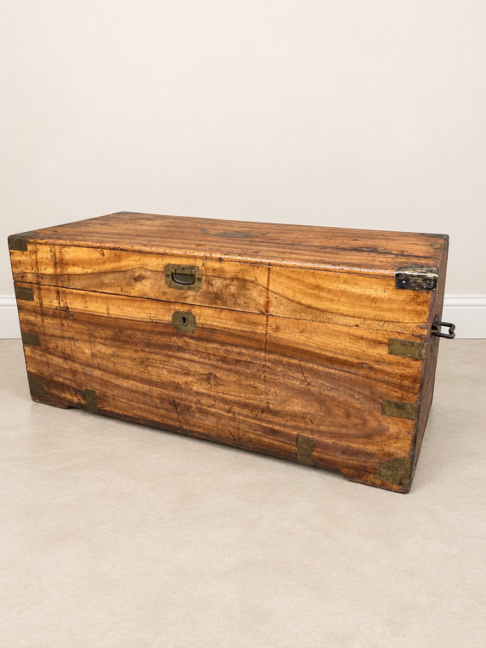 A 19th-century rectangular wooden campaign chest featuring protective brass corner brackets, flush carrying handles, and a hinged lid. View VI