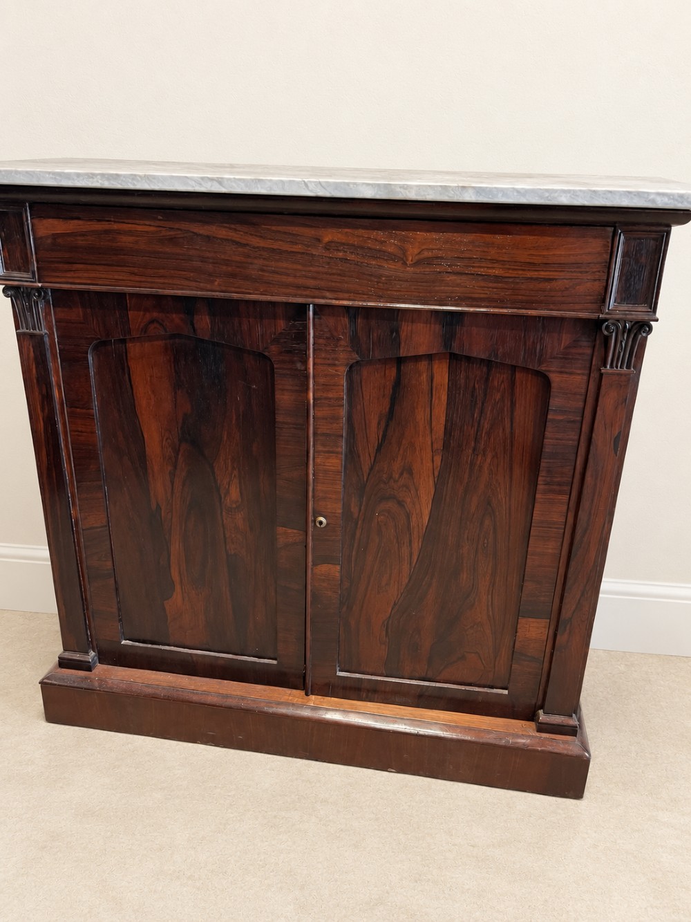 A pair of 19th-century Regency dark rosewood cupboards featuring white marble tops and panelled double doors on plinth bases. View III