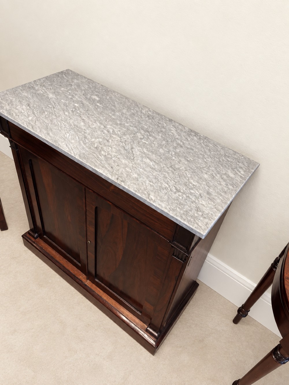 A pair of 19th-century Regency dark rosewood cupboards featuring white marble tops and panelled double doors on plinth bases. View IV