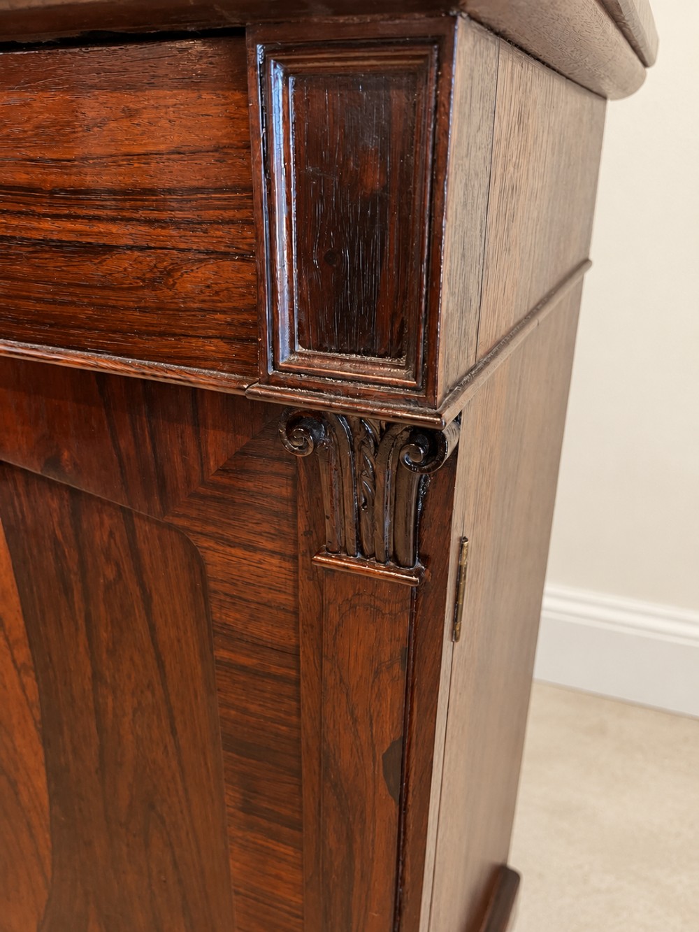 A pair of 19th-century Regency dark rosewood cupboards featuring white marble tops and panelled double doors on plinth bases. View V