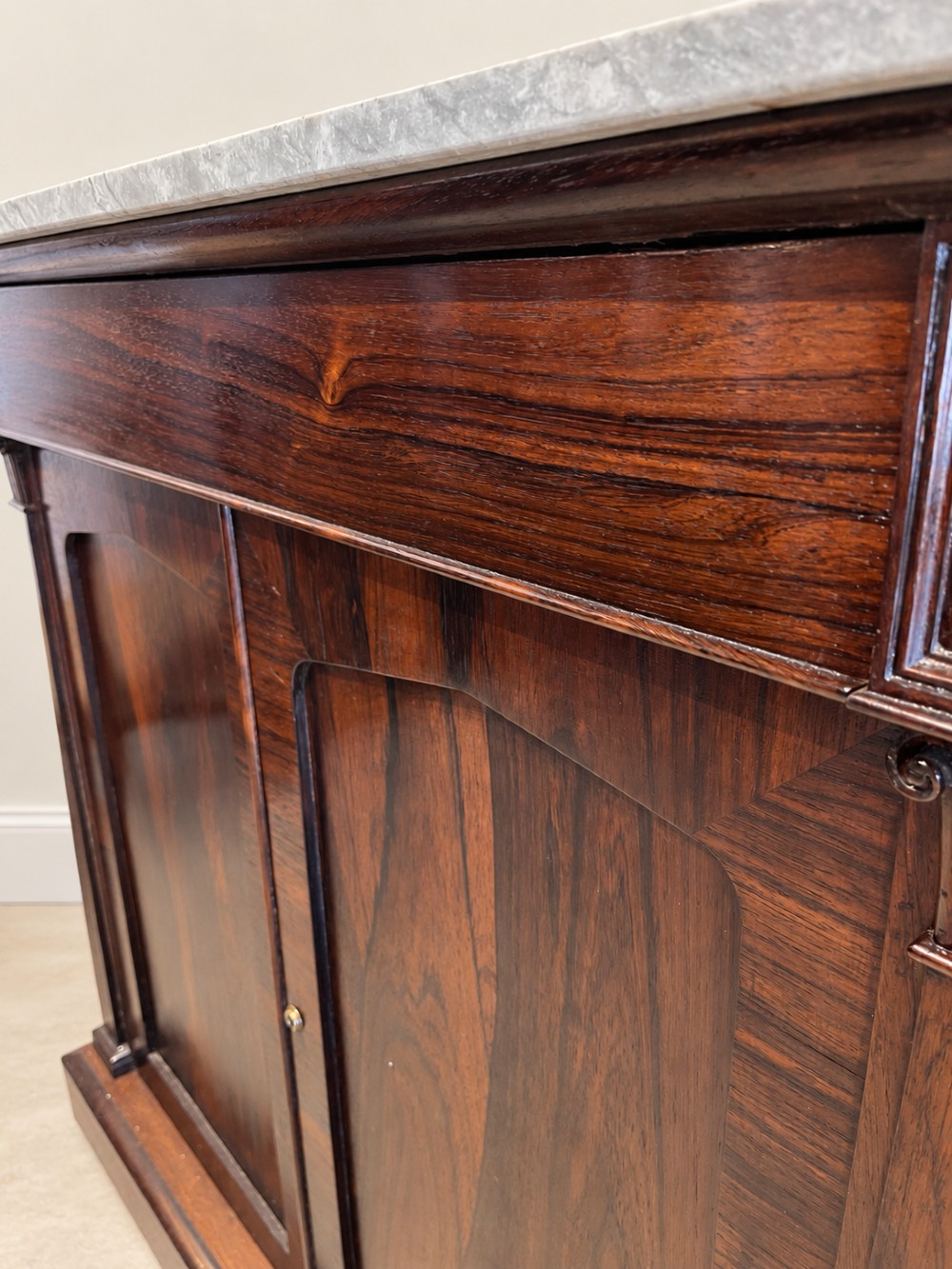 A pair of 19th-century Regency dark rosewood cupboards featuring white marble tops and panelled double doors on plinth bases. View VII