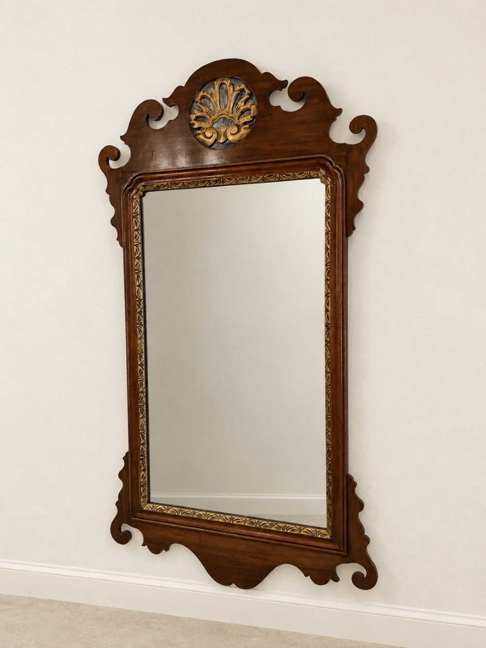 A Georgian mahogany fretwork wall mirror featuring a scrollwork frame, gilt shell cresting detail, and a gilded inner border. View III